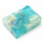 Bar of soap with a seashell and wave design on a white background