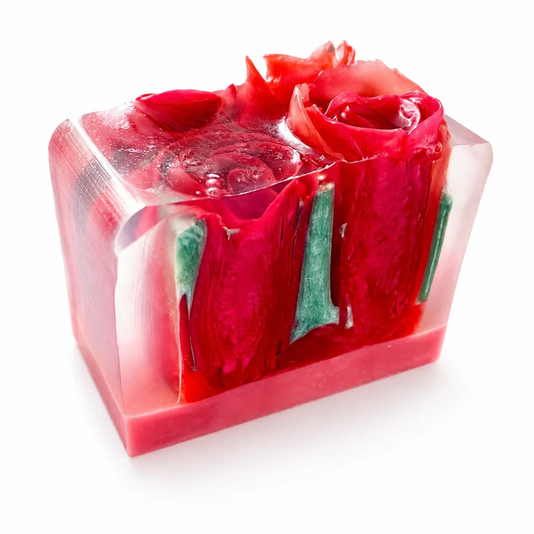 Red rose soap bar with green leaves on a white background