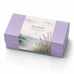 Purple soap packaging with nature-themed design and 'SUDSI' branding.